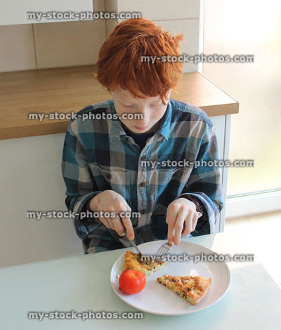 Stock image of child having omelette and tomato breakfast 