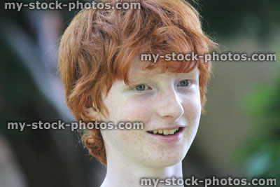 Stock image of boy, boy's face smiling and laughing, red hair