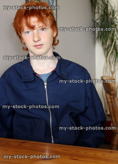 Stock image of teenage boy with blue jacket, red hair, listening, conversation