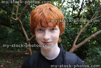 Stock image of teenage boy on woodland walk, hiking through countryside, backpack / rucksack