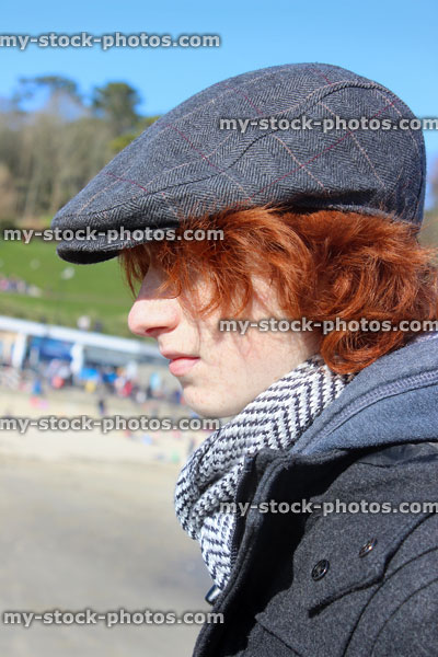 Stock image of boy with red hair wearing grey flat cap
