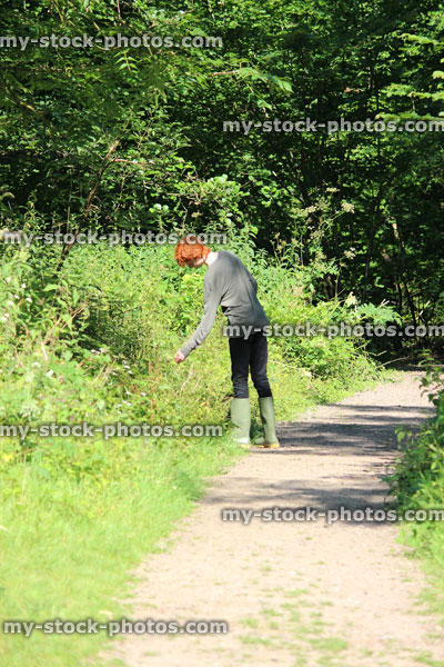 Stock image of teenage boy walking along pathway, footpath, wood / woodland / forest, red hair