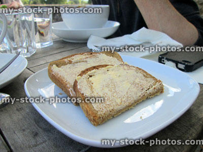 Stock image of wholemeal brown bread and butter on plate, side dish