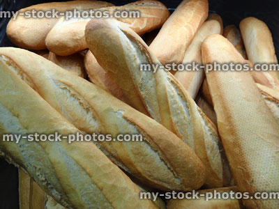 Stock image of bakery with freshly baked bread sticks / baguettes in-basket