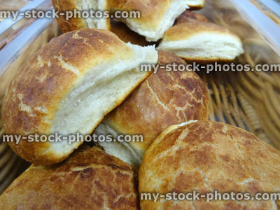 Stock image of freshly baked homemade white crusty bread rolls, wicker basket