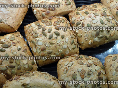 Stock image of bakery with square bread rolls, topped with sunflower-seeds