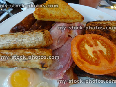 Stock image of fry up / fried breakfast with vegetarian sausages, bacon, tomato, egg