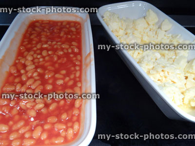 Stock image of full English fried breakfast buffet, baked beans, scrambled egg, serving tongs