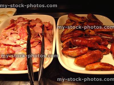Stock image of fried breakfast buffet with bacon and sausage platters