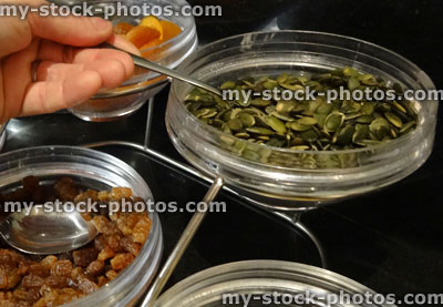 Stock image of glass bowls with nuts and dried fruit, pumpkin seeds, sultanas, dried apricots