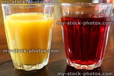 Stock image of glasses of orange juice and cranberry juice