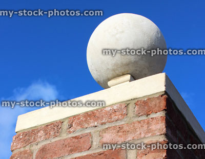 Stock image of red brick gate post, stone ball finial / pier cap