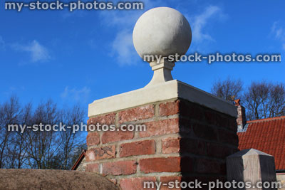 Stock image of red brick gate post, stone ball finial / pier cap