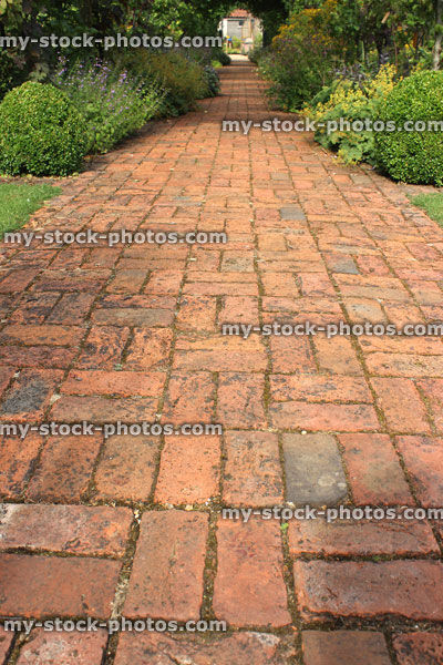 Stock image of old red brick path, block paving, paved pathway