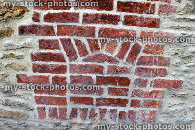 Stock image of old bread oven in wall, hole bricked up