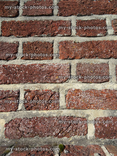 Stock image of dirty wall with cement mortar on red bricks