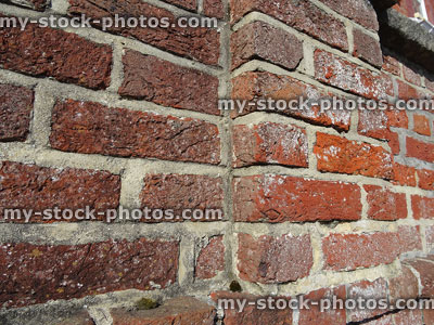 Stock image of red brick wall with cement pointing, side elevation