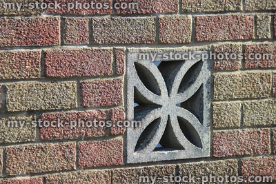 Stock image of flower shaped cement air bricks / concrete vent blocks, brick wall