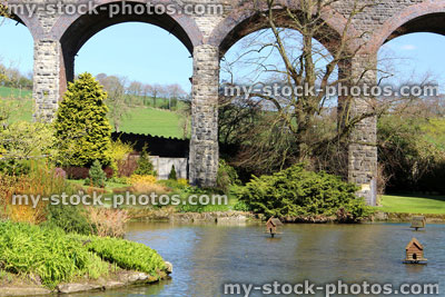 Stock image of mill pond with a viaduct background on a sunny day