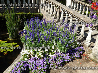 Stock image of park garden with stone bridge, annual flowers, pond