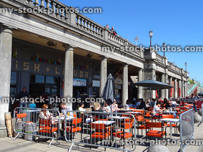 Stock image of al-fresco dining on Brighton promenade, by pier / beach