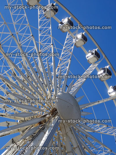 Stock image of large Ferris wheel attraction pictured against blue sky