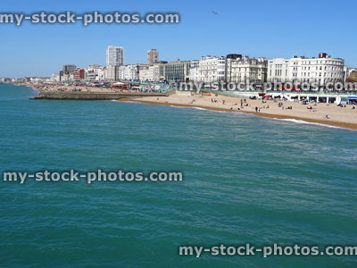 Stock image of Brighton seafront and sandy-beach, hotels, shops and tourists