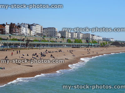 Stock image of sunbathers on sunny Brighton beach, sun, sea, sand