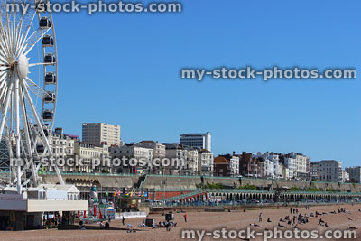 Stock image of Brighton beach, summer holiday makers, tourists and sunbathers, big wheel