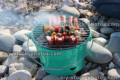 Stock image of charcoal barbecue with smoking hot coals, cooking kebabs