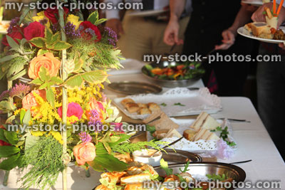Stock image of people serving themselves, buffet table, party food, 
