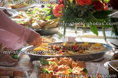 Stock image of buffet food with vegetarian options, couscous salad platter