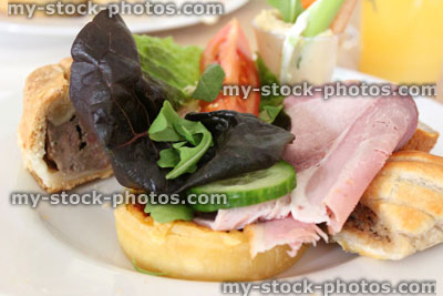 Stock image of party food on plate, ham, pork pie, sausage roll, salad, tomato, quiche