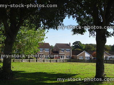 Stock image of modern housing estate next-to playground, park and trees