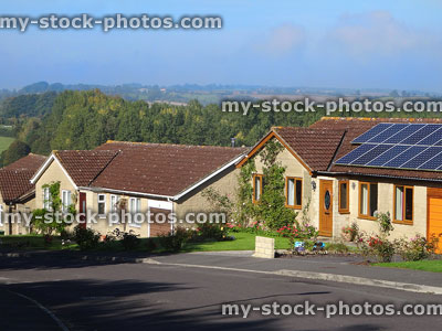Stock image of bungalows with solar panels of roofs, countryside views