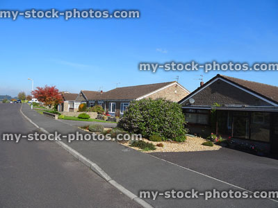 Stock image of housing estate with bungalows, driveways and front gardens