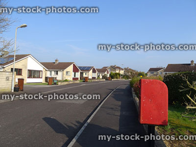 Stock image of red postbox, housing estate with bungalows for seniors
