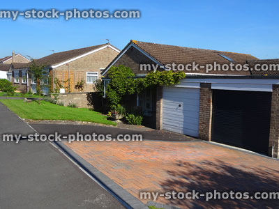 Stock image of block-paved driveways on housing estate with bungalows / pavement