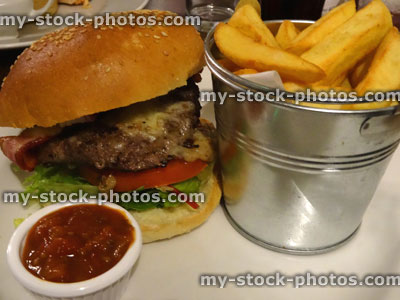 Stock image of gourmet burger, chunky chips in bucket, tomato ketchup