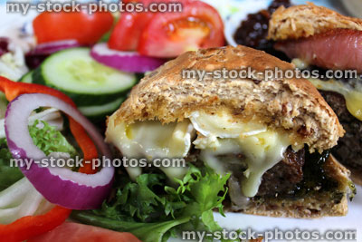 Stock image of homemade gourmet beef burger, cheese burger, brie cheese, bacon, salad