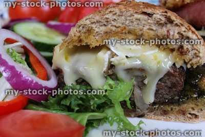 Stock image of homemade gourmet beef burger, cheese burger, brie cheese, bacon, salad