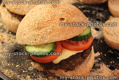 Stock image of cheese burgers with tomato slices, cucumber, melted cheese