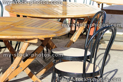 Stock image of round French bistro tables and chairs outside pavement cafe