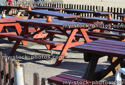 Stock image of wooden picnic tables at beach cafe, alfresco dining