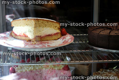 Stock image of Victoria sponge cake in glass cabinet, fresh cream
