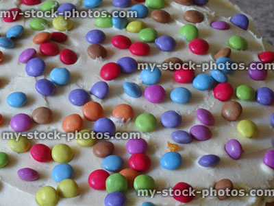 Stock image of homemade sponge cake, decorated with icing, chocolate sweets