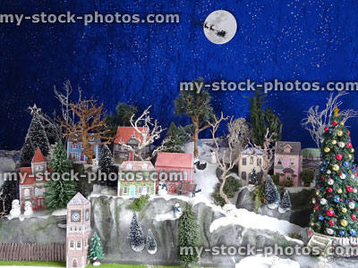 Stock image of cardboard model Christmas village on mountains with trees