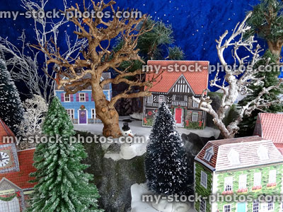 Stock image of model card houses in Christmas village, miniature snowmen, tree