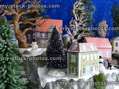 Stock image of snowy mountain with Christmas village, cut out paper houses