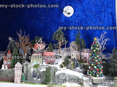 Stock image of scenic Christmas village display, cut out / folded printable paper houses